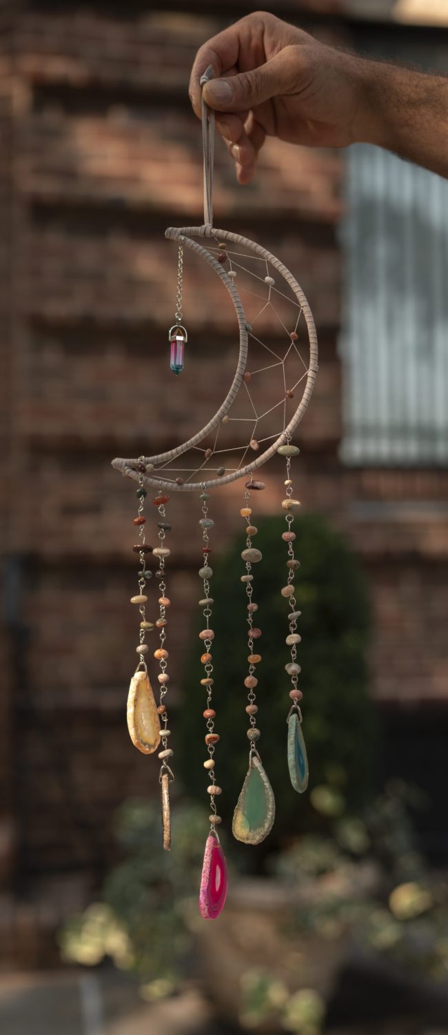 hand-holding-dream-catcher-outdoors